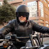 Man riding a motorcycle in an urban setting