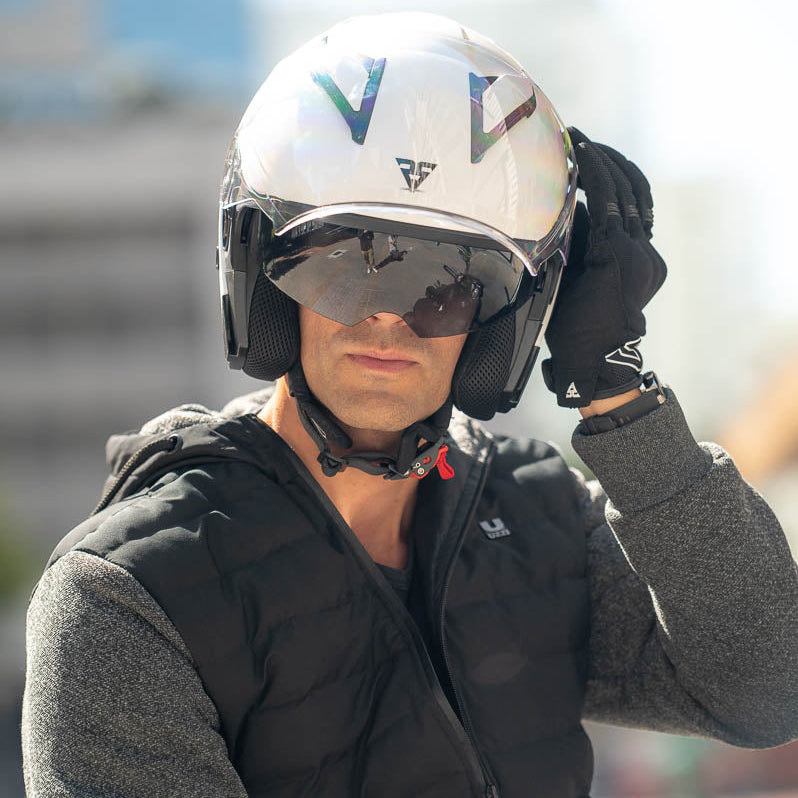 Person wearing a helmet with a visible brand logo, standing outdoors.