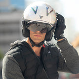 Person wearing a helmet with a visible brand logo, standing outdoors.
